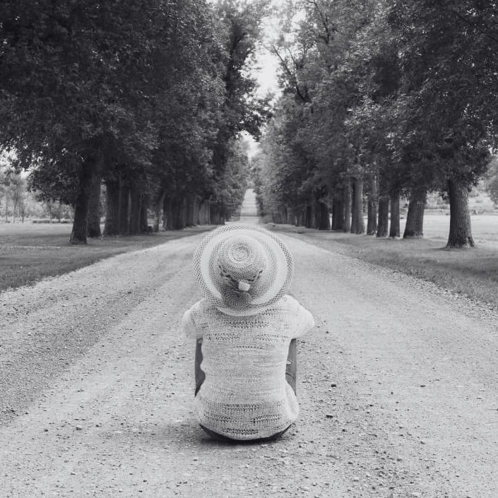 Woman sitting in the middle of the road for blog post WAITING